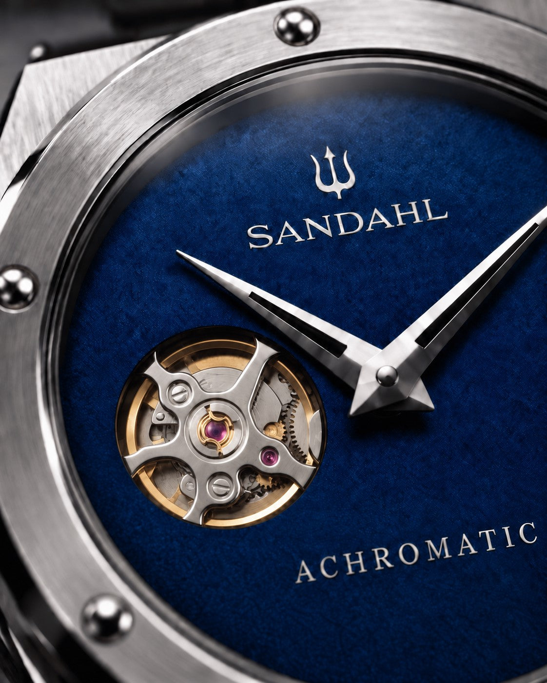 Close-up of the blue SANDAHL ACHROMATIC Cobalt dial, showing the open-heart aperture and polished hands.