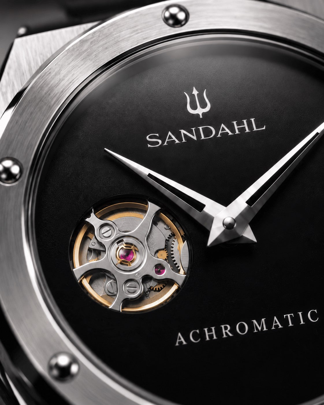Close-up of the black SANDAHL ACHROMATIC Musou dial, showing the open-heart aperture and polished hands.