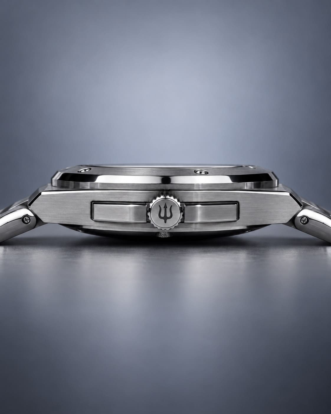 Side profile of the SANDAHL ACHROMATIC steel case and bracelet, showing the crown engraved with a trident.