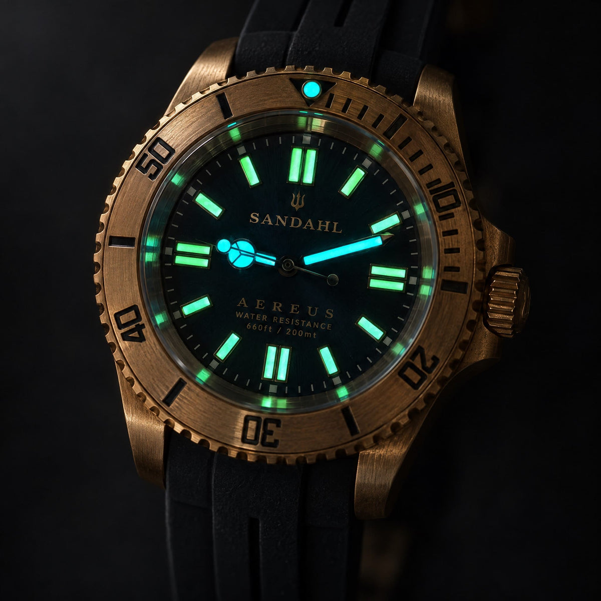 SANDAHL AEREUS bronze watch with luminous hands and hour markers against a dark background.