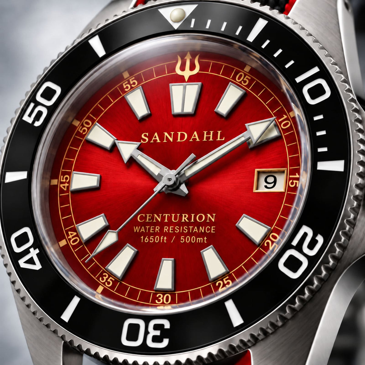 Close-up of the red SANDAHL CENTURION Signal Red dial, luminous markers, polished hands, date window and trident.