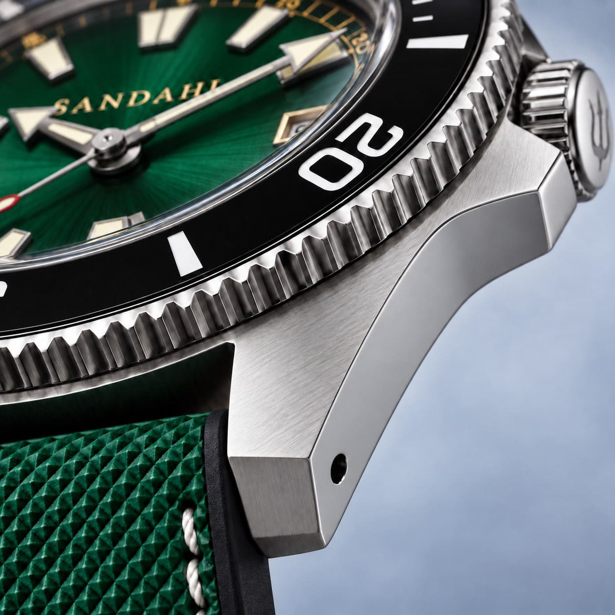 Close-up of the SANDAHL CENTURION Trench Green stainless steel case, showing brushed lugs, polished sides and a black dive bezel.
