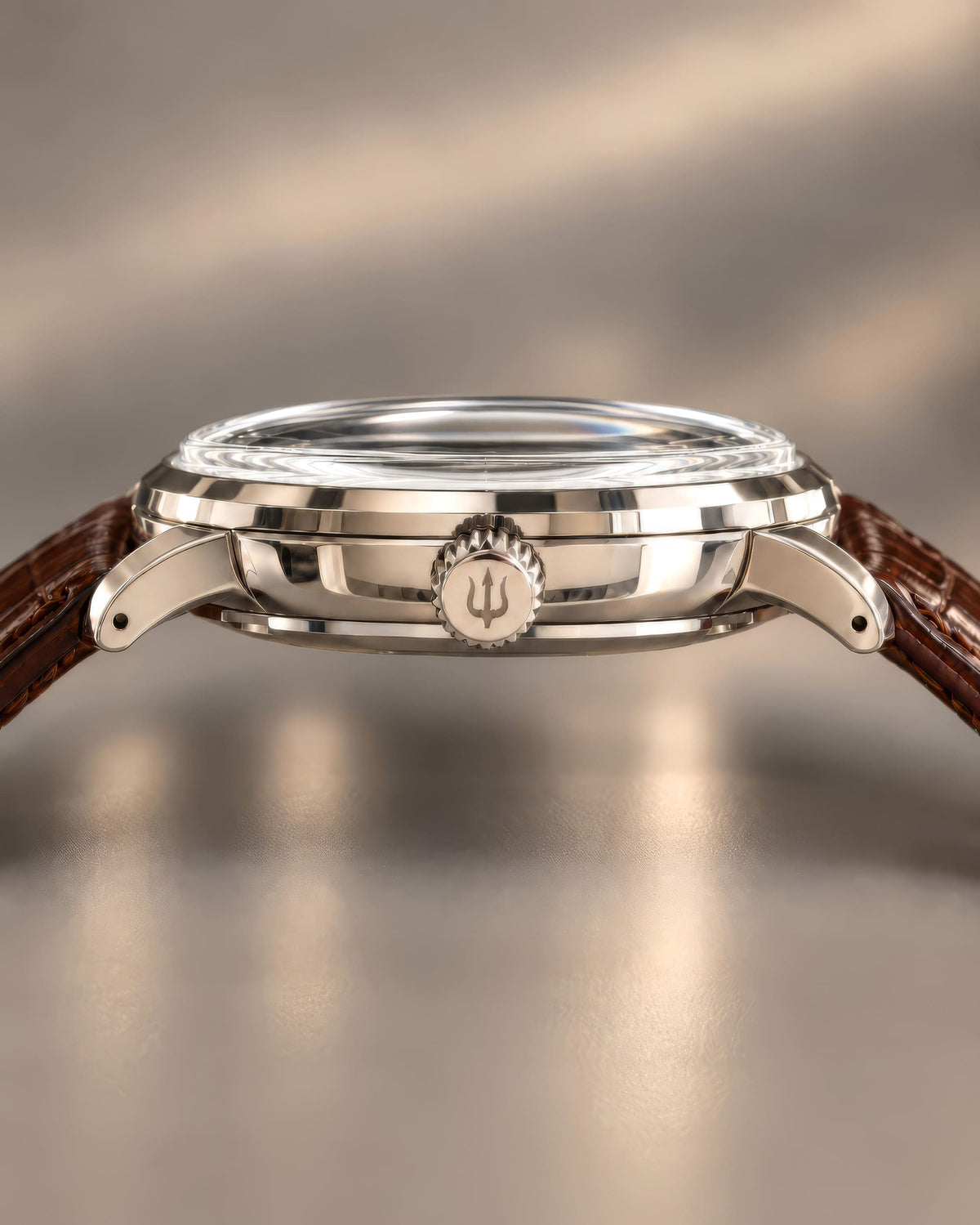 Side profile of SANDAHL ORNATUS Malachite, showing its polished steel case, rounded lugs and trident-engraved crown.