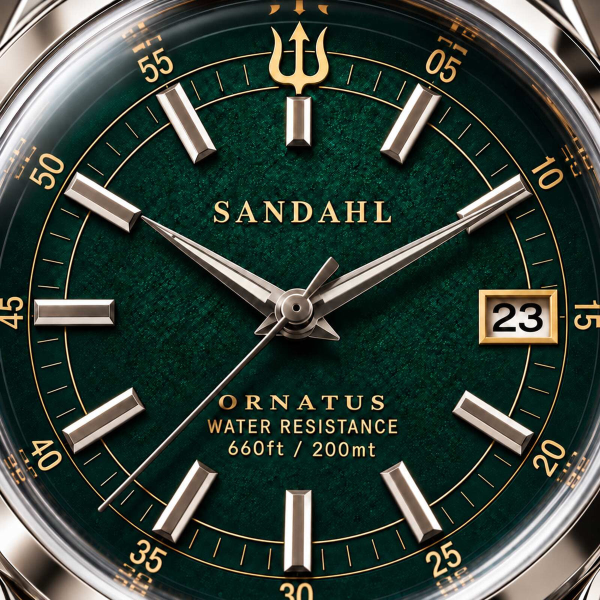 Macro view of the textured green dial of SANDAHL ORNATUS Malachite, with polished hands, applied hour markers and a gold trident.