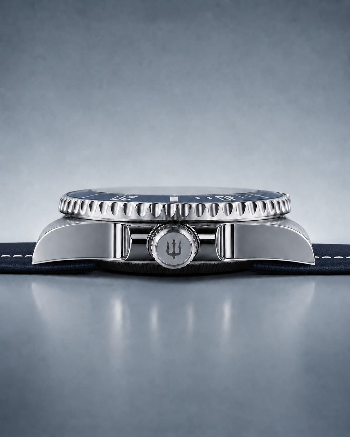Side profile of SANDAHL SHALLOW Kattegatt Blue, showing the polished steel case, crown and stitched fabric strap.
