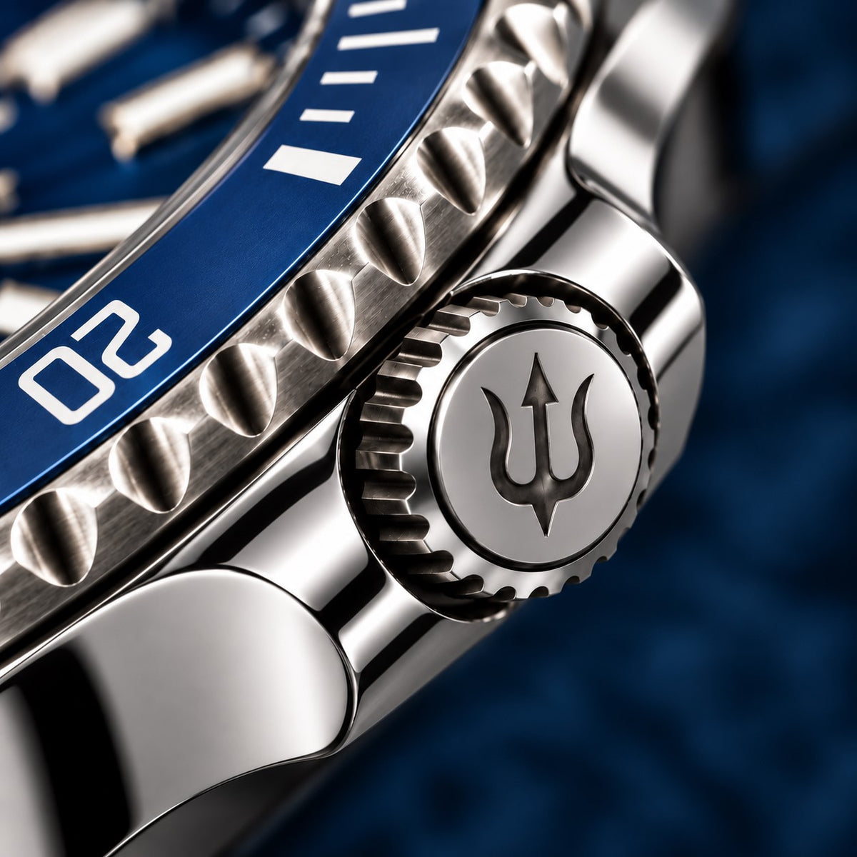 Trident-engraved crown and polished crown guards on SANDAHL SHALLOW Kattegatt Blue, beside the blue dive bezel.