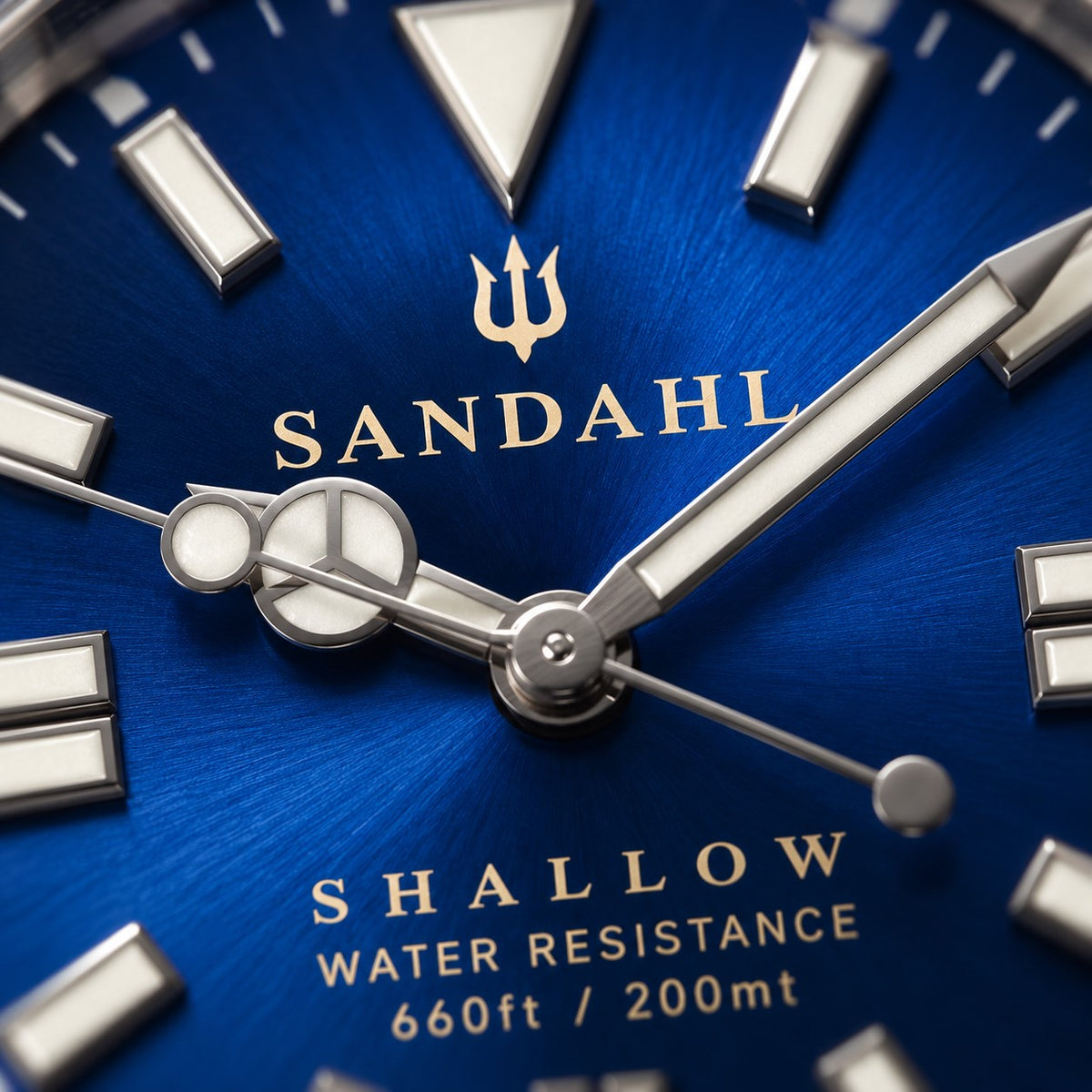 Macro detail of the blue dial on the SANDAHL SHALLOW Kattegatt Blue, featuring LumiSand hour markers and hands.