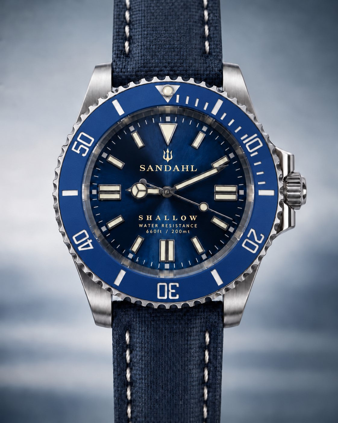 SANDAHL SHALLOW Kattegatt Blue with blue sunburst dial, blue dive bezel and navy sailcloth strap, photographed straight on.