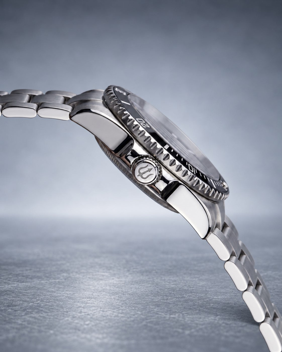 Angled side view of SANDAHL SHALLOW Sea Mist Silver, showing the steel case, crown guards and bracelet.