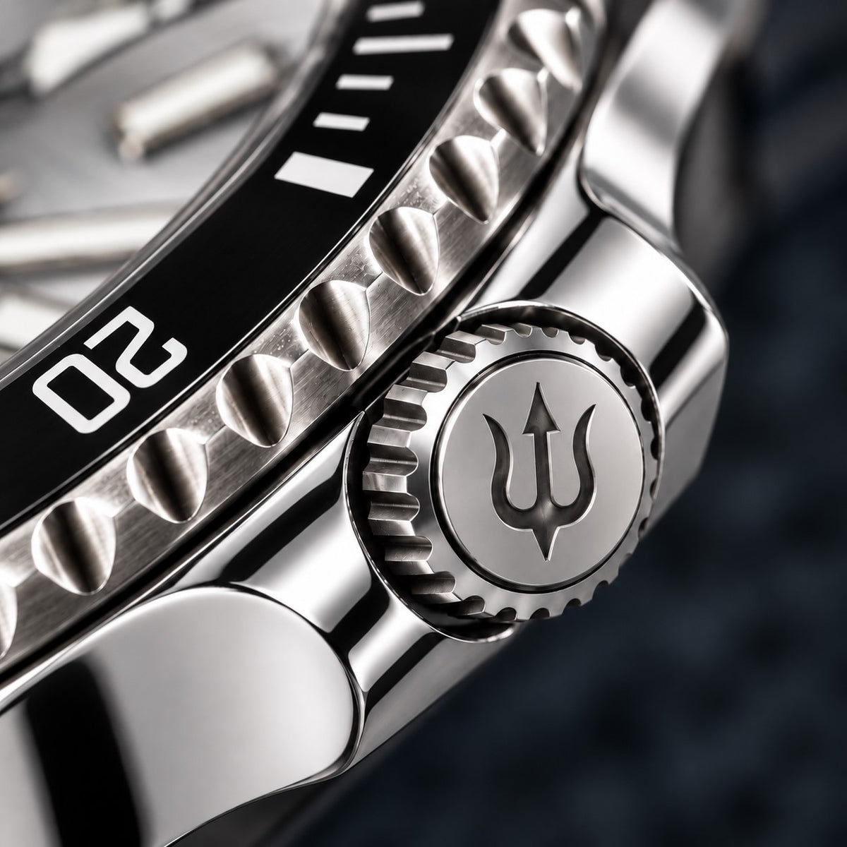 Trident-engraved crown and polished crown guards on SANDAHL SHALLOW Sea Mist Silver, beside the black dive bezel.