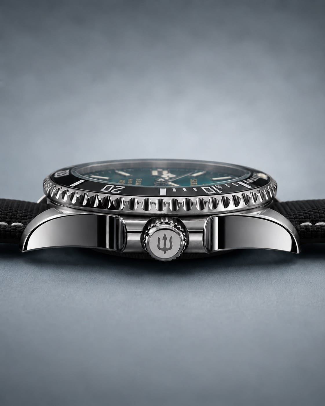 Low angled view of SANDAHL SHALLOW Skagerrak Teal, showing the dial, dive bezel and stitched fabric strap.