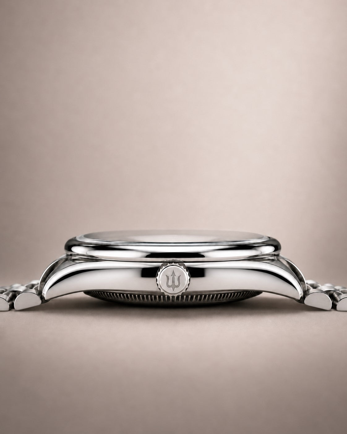 Side profile of a SANDAHL SUITS watch, showing the polished steel case, rounded bezel and trident-engraved crown.