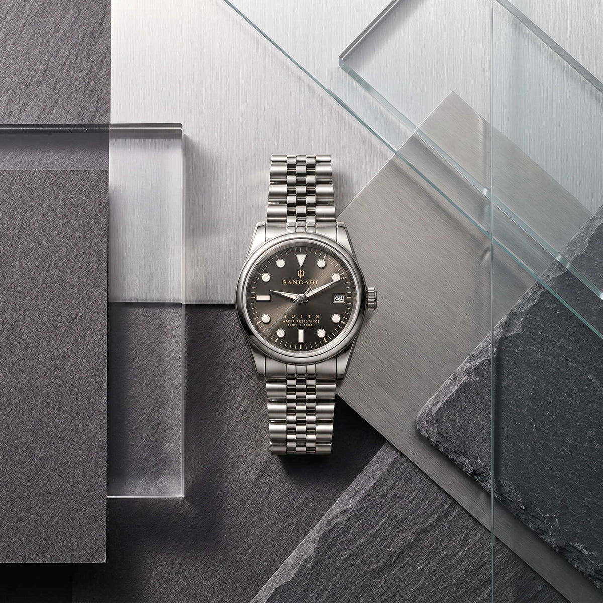 SANDAHL SUITS Savile Taupe with a Jubilee bracelet, arranged with grey stone, brushed steel and glass panels.
