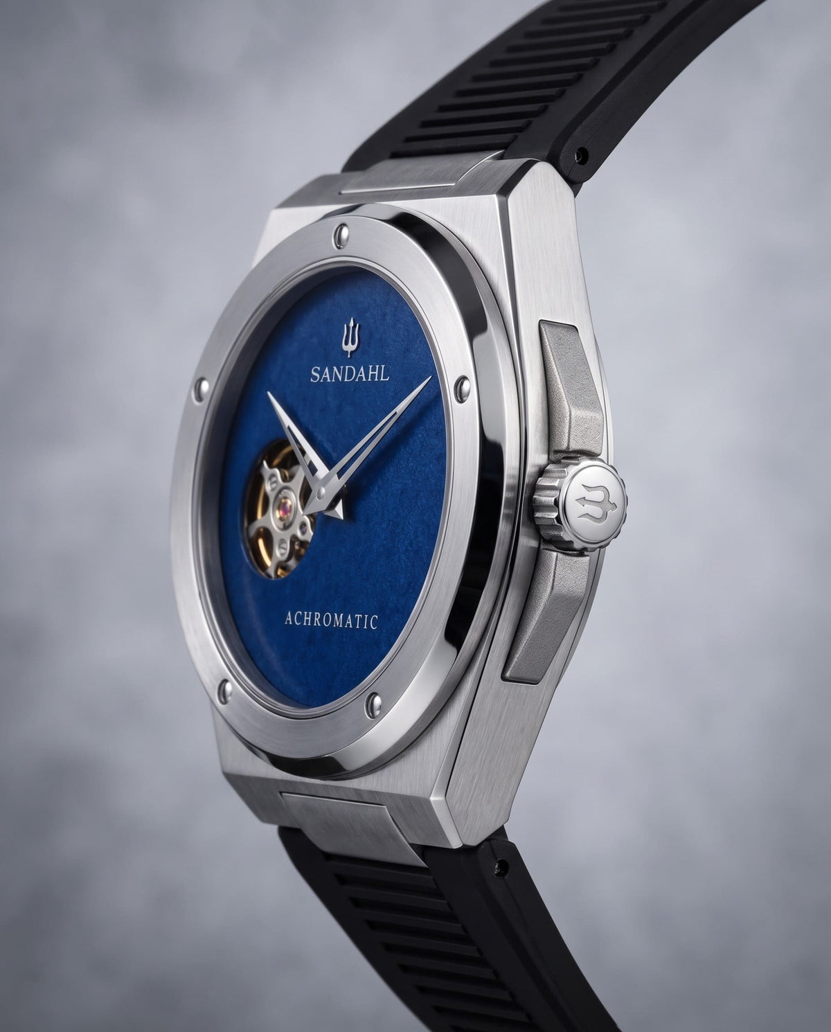 Angled view of the SANDAHL ACHROMATIC Cobalt with a blue dial, steel case and black rubber strap.