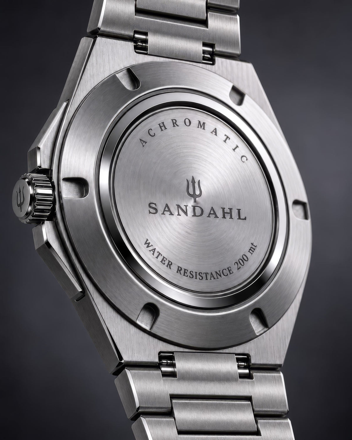 Rear view of the SANDAHL ACHROMATIC with a steel bracelet and brushed steel caseback engraved with the brand and trident.