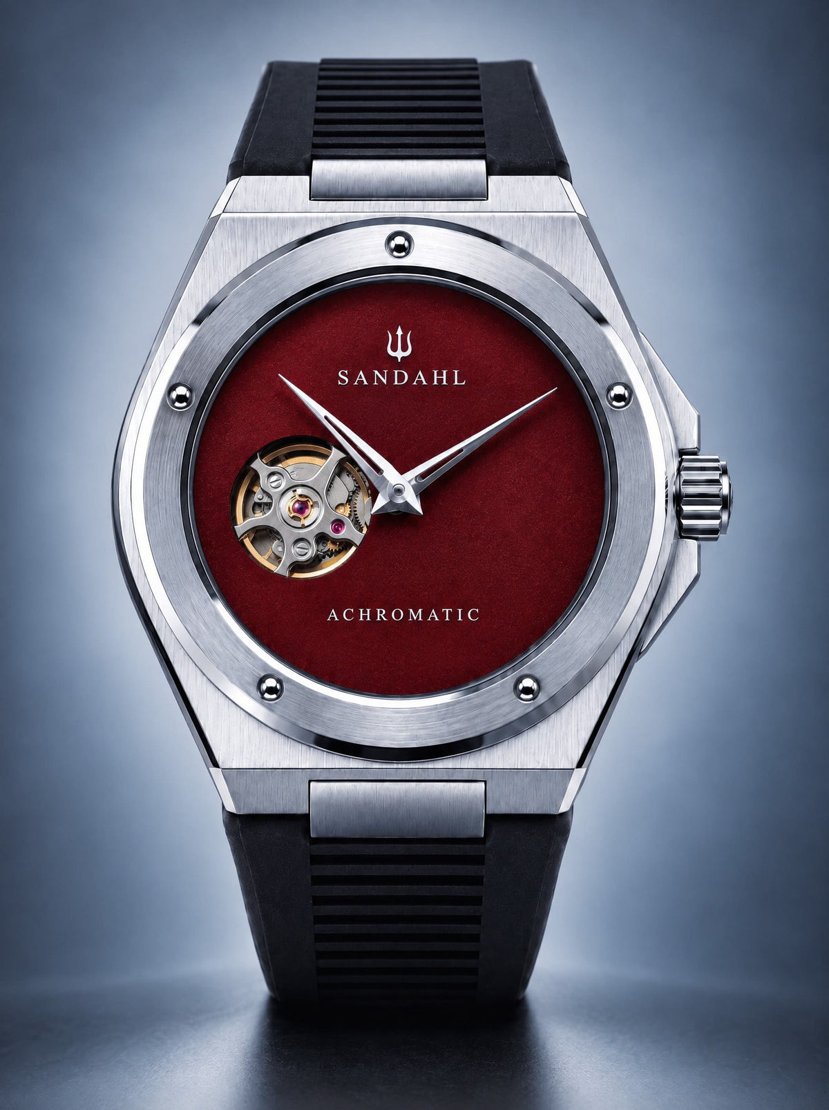 SANDAHL ACHROMATIC Crimson with a red open-heart dial and black rubber strap, viewed from the front.