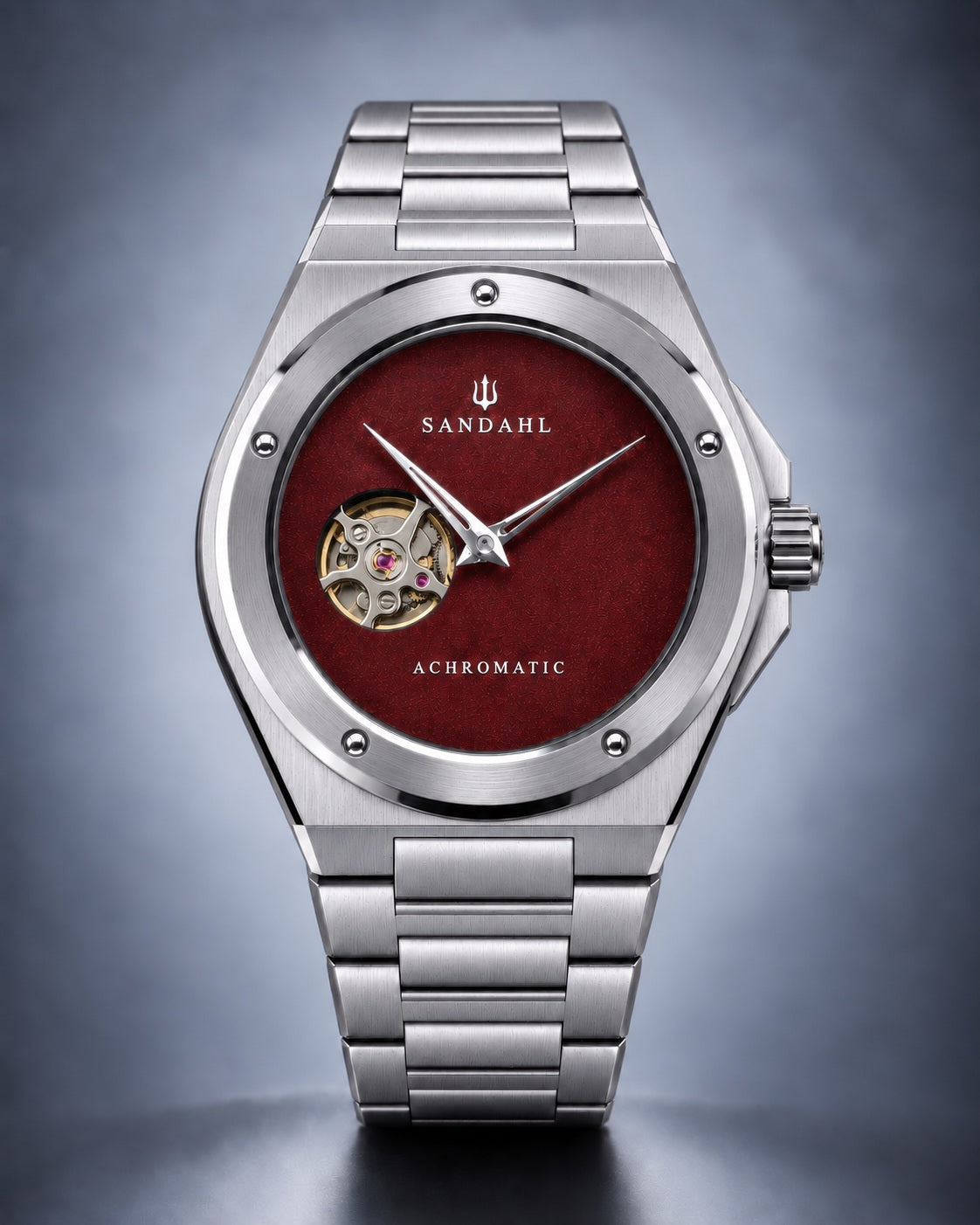 SANDAHL ACHROMATIC Crimson with a red open-heart dial and stainless steel bracelet, viewed from the front.