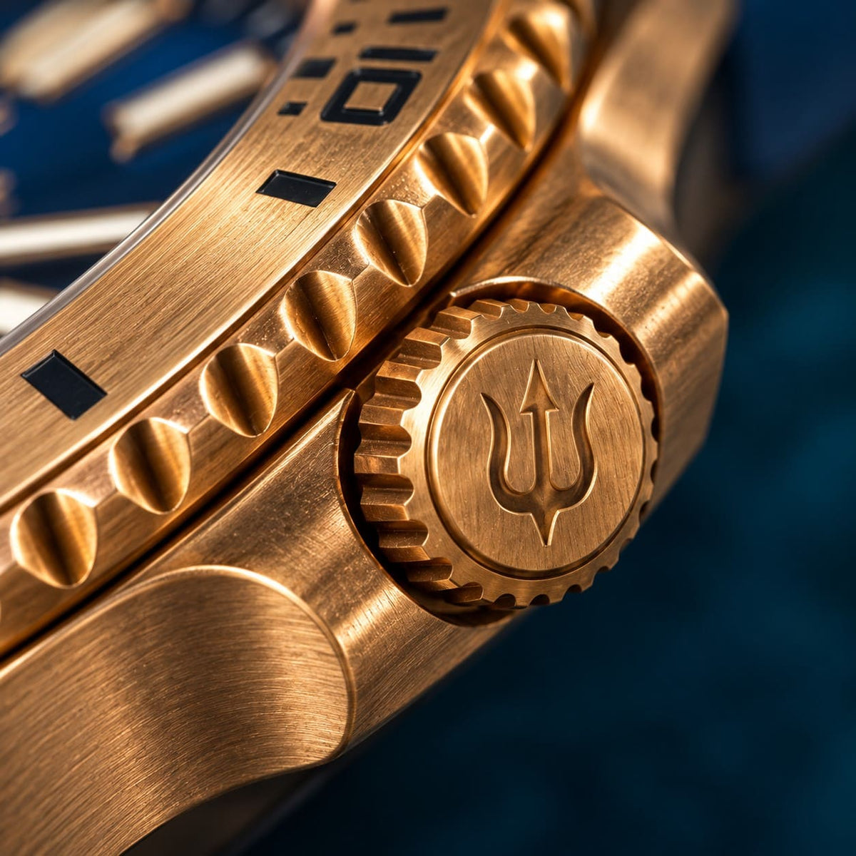 Close-up of the SANDAHL AEREUS Patina Teal bronze crown with engraved trident, beside the teal dial and brushed bronze bezel.