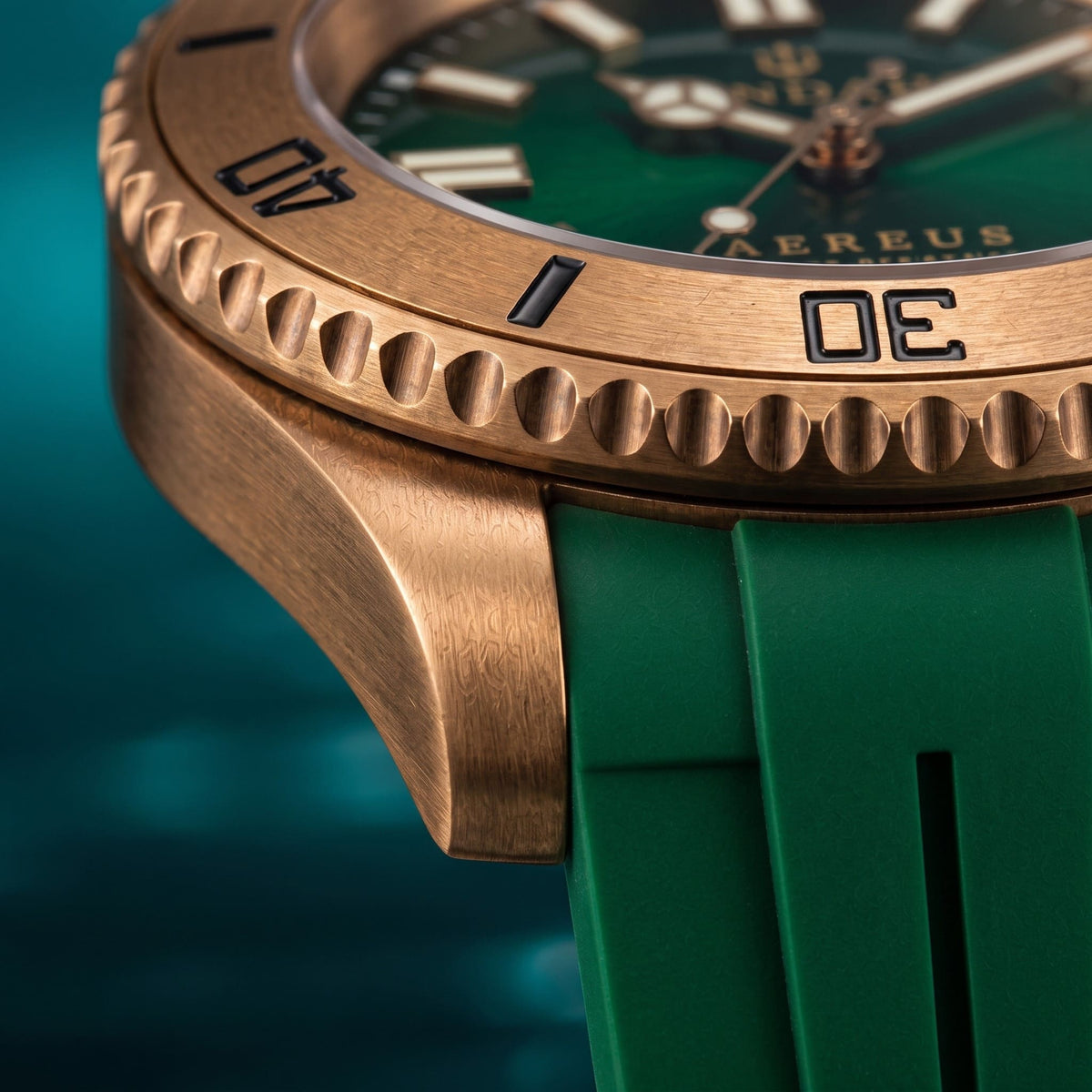 Close-up of the SANDAHL AEREUS Emerald current brushed bronze case, scalloped dive bezel and black rubber strap.