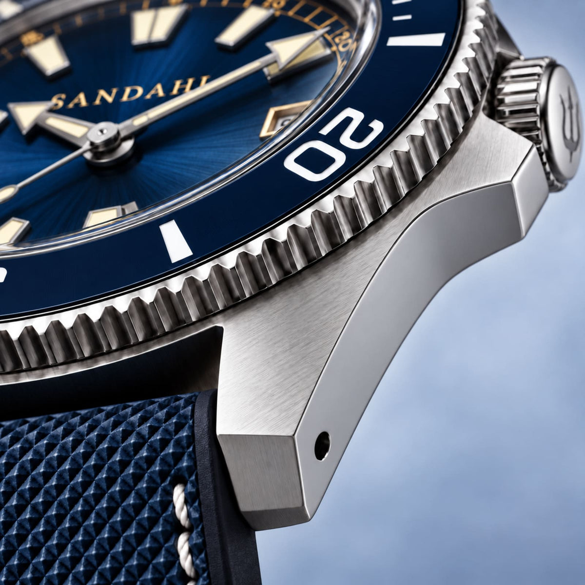 Macro view of the SANDAHL CENTURION Abyss Blue brushed steel case, lugs and blue dive bezel.