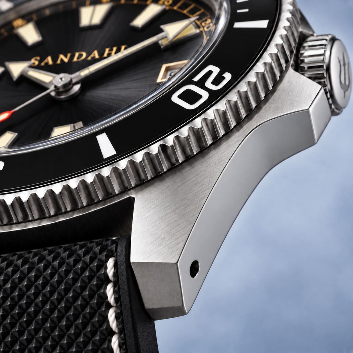 Macro view of the SANDAHL CENTURION Blackwater brushed steel lugs, black bezel and textured black strap.