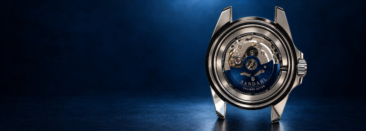 SANDAHL CENTURION stainless steel case with its exposed movement and blue CALIBRE SC100 rotor, positioned on the right against a dark navy background.