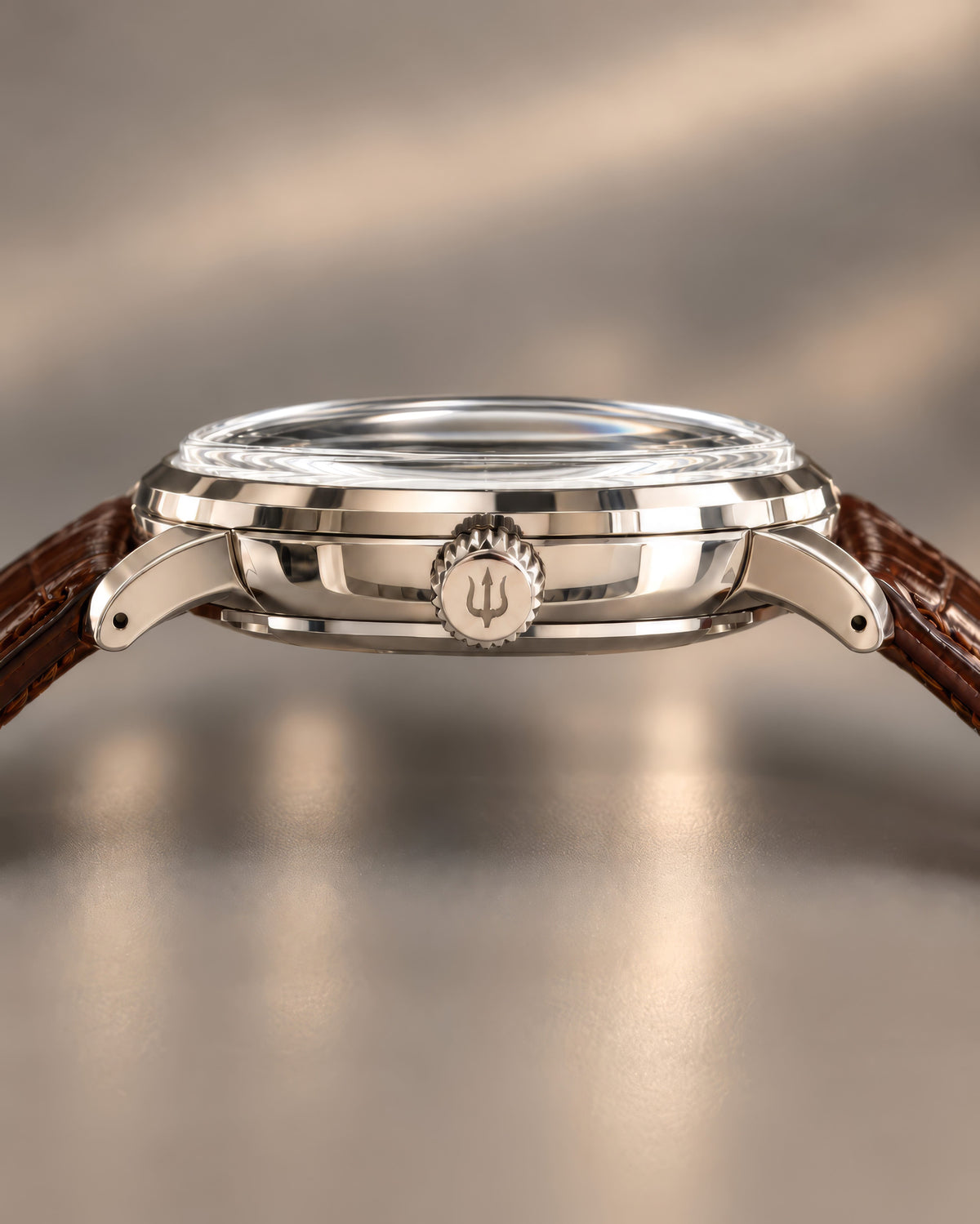 Side profile of SANDAHL ORNATUS Cobalt, showing its polished steel case, rounded lugs and trident-engraved crown.