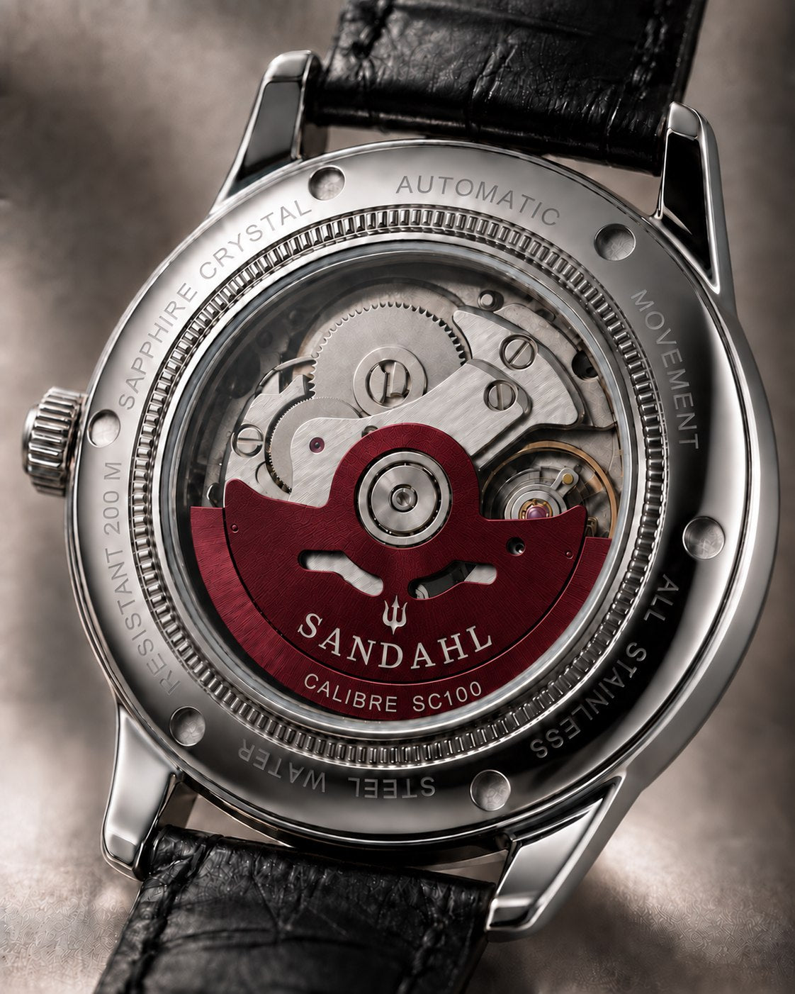 SANDAHL ORNATUS Garnet exhibition caseback showing the automatic movement and burgundy rotor engraved CALIBRE SC100.