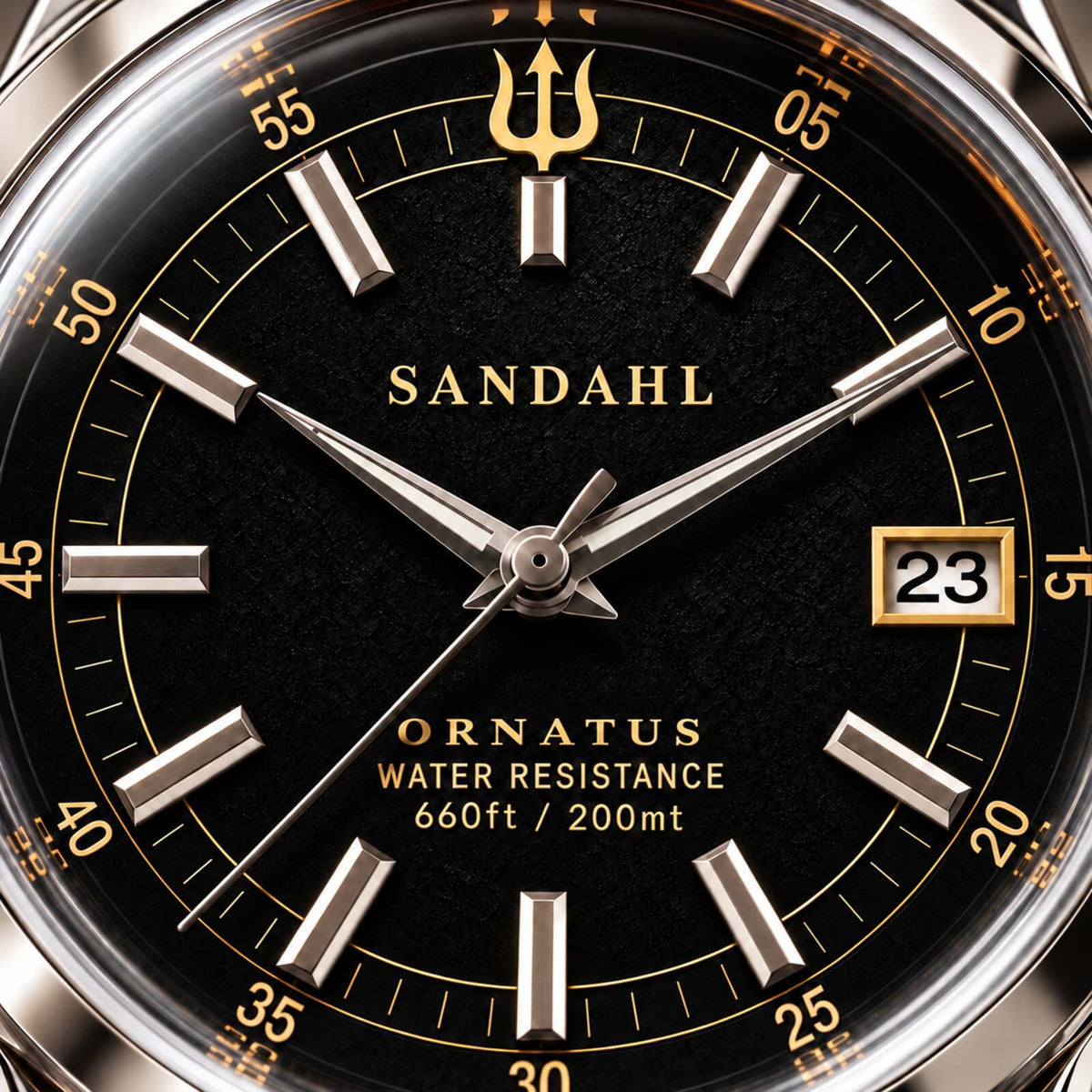 Macro view of the textured black dial of SANDAHL ORNATUS Onyx, with polished hands, applied hour markers and a gold trident.