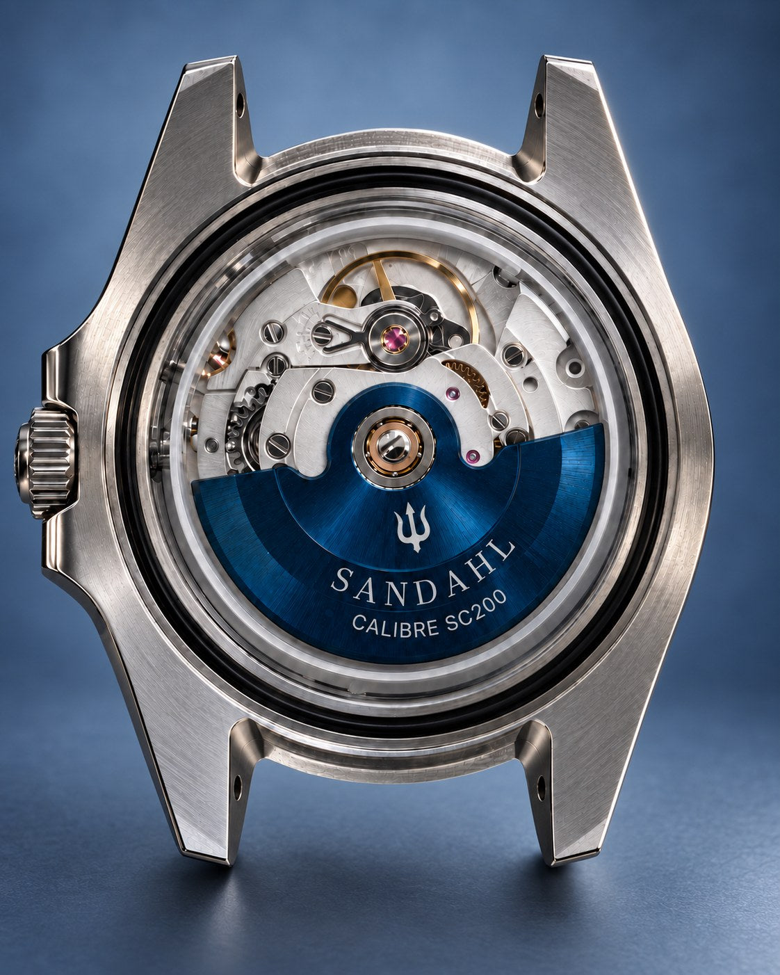 SANDAHL SHALLOW stainless steel watch without a strap or caseback, showing the blue rotor engraved CALIBRE SC200 against a slate blue background.