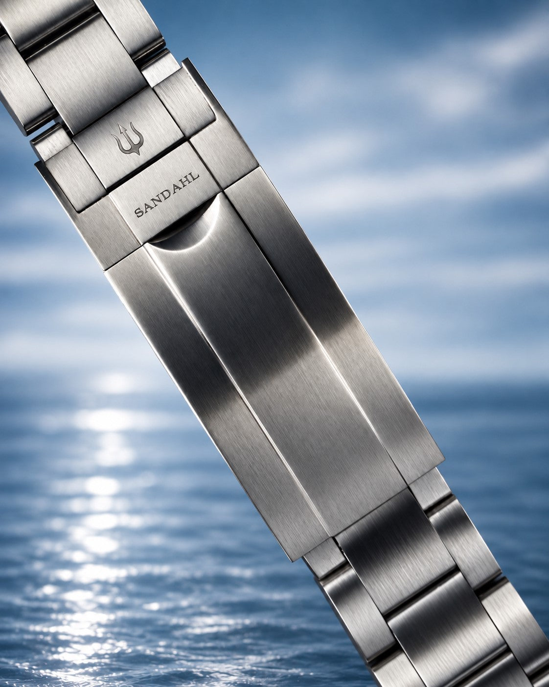 Close-up of a SANDAHL SHALLOW steel bracelet clasp engraved with SANDAHL and the trident.