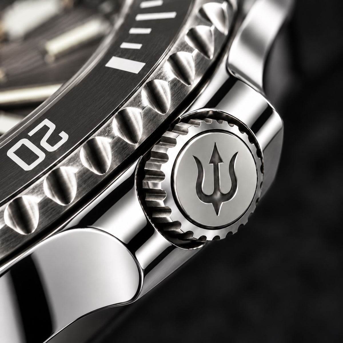 Trident-engraved crown and polished crown guards on SANDAHL SHALLOW Granite Grey, beside the black dive bezel.