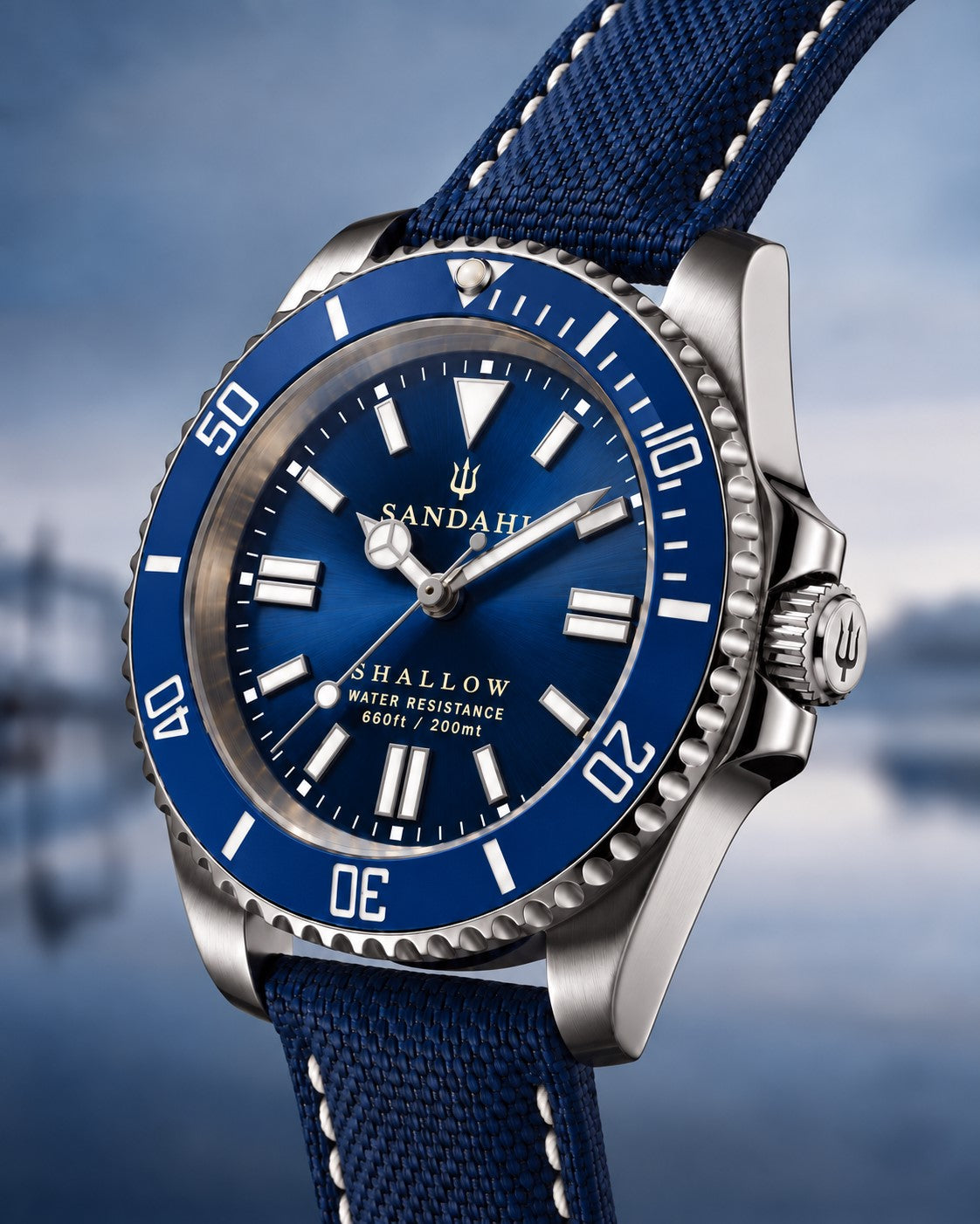 SANDAHL SHALLOW Kattegatt Blue in an angled product view with blue sunburst dial, blue dive bezel and navy sailcloth strap.
