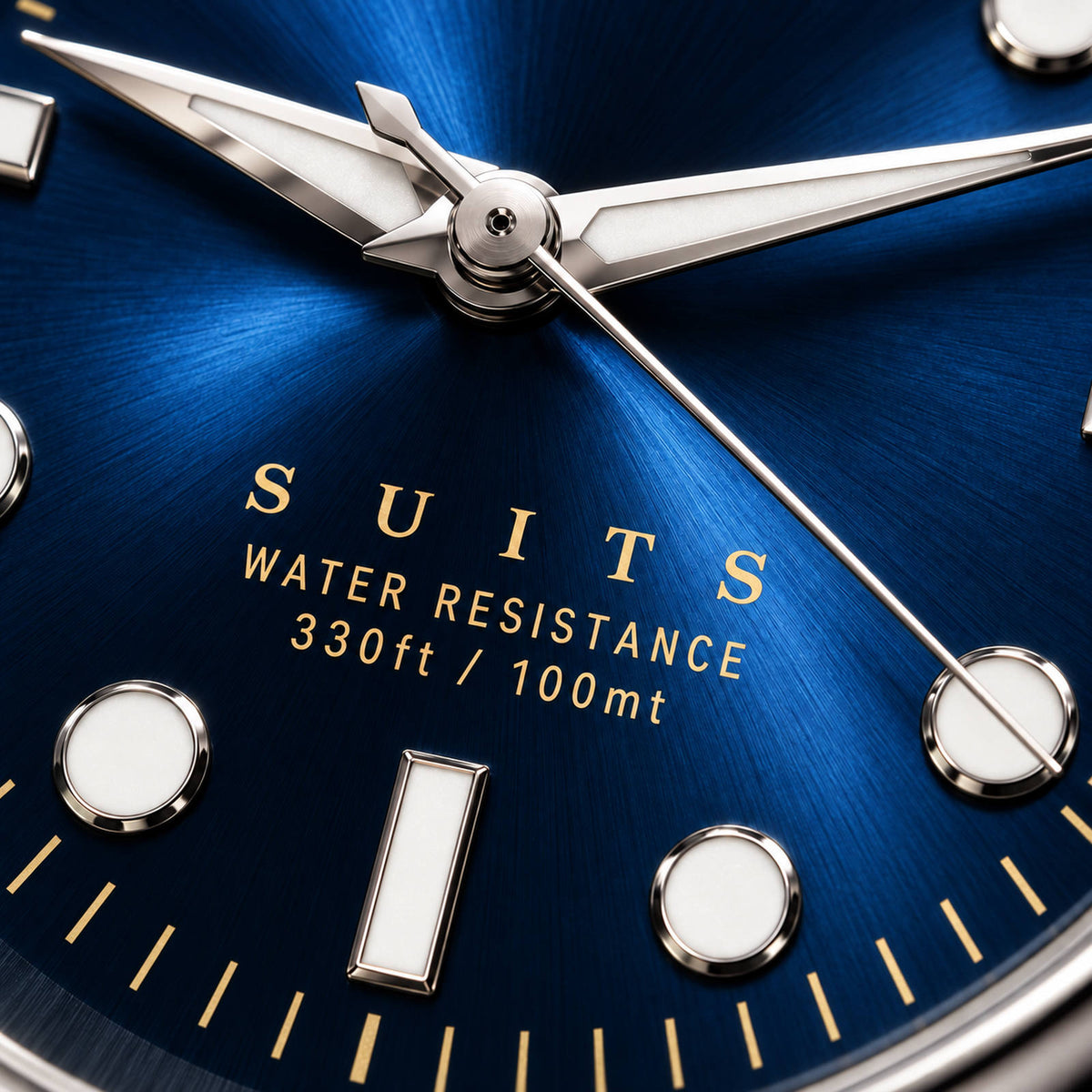 Extreme close-up of the SANDAHL SUITS blue dial, showing its sunburst texture, gold lettering and polished hands and hour markers.