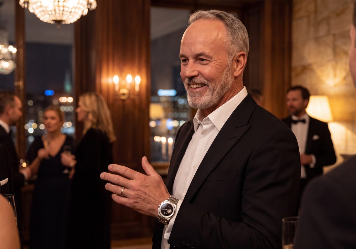 SANDAHL watch worn by a man in a black suit during an elegant evening event.
